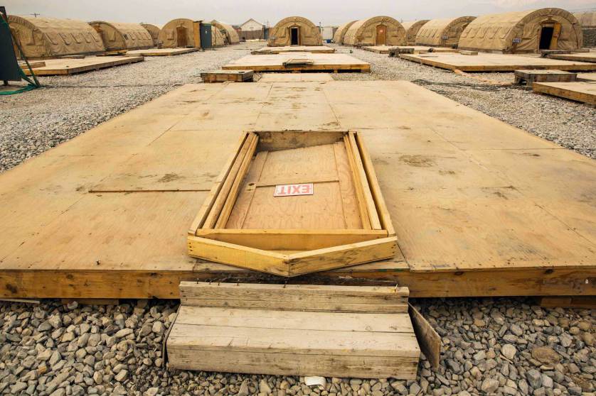 A door rests on the floor of a tent that has been dismantled as part of areas being demolished on the massive Bagram Air Field in the Parwan province of Afghanistan